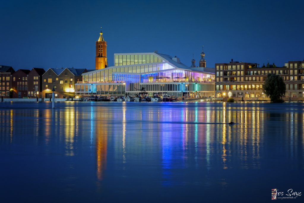 a building with lights on the water