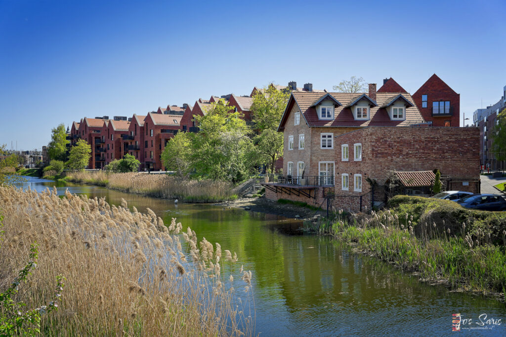 a row of houses next to a river