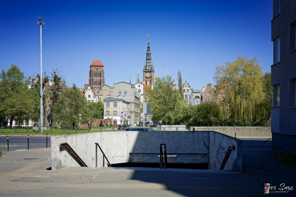 a concrete ramp with a clock tower in the background