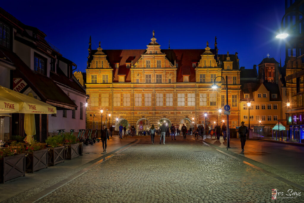 a large building with people walking in the middle of it