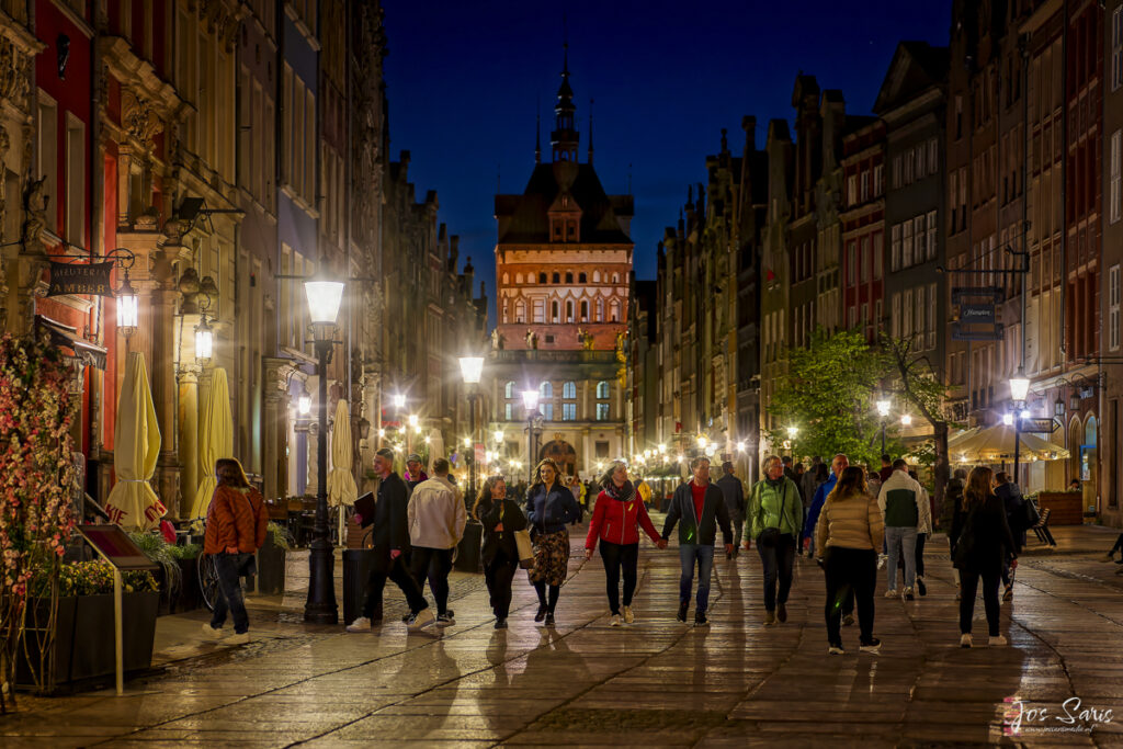 a group of people walking down a street