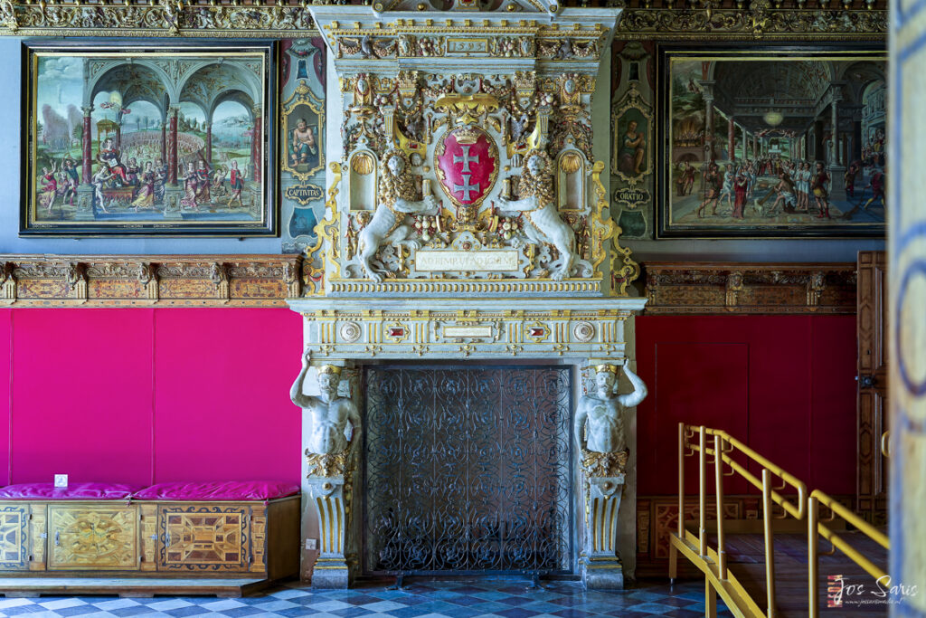 a ornate fireplace with art on the wall