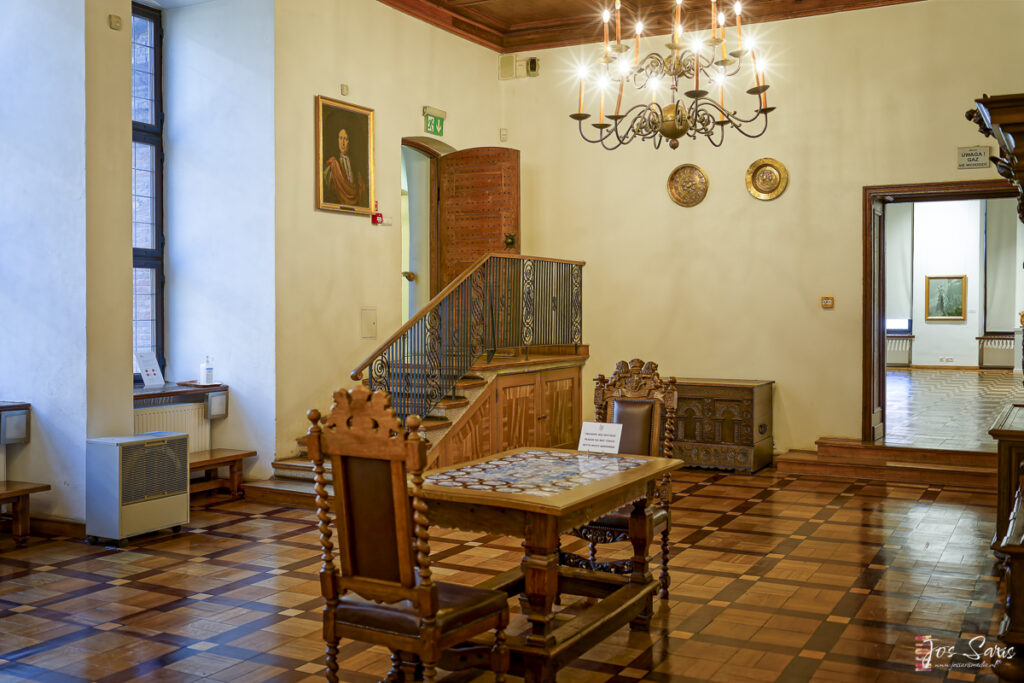 a room with a chandelier and a table