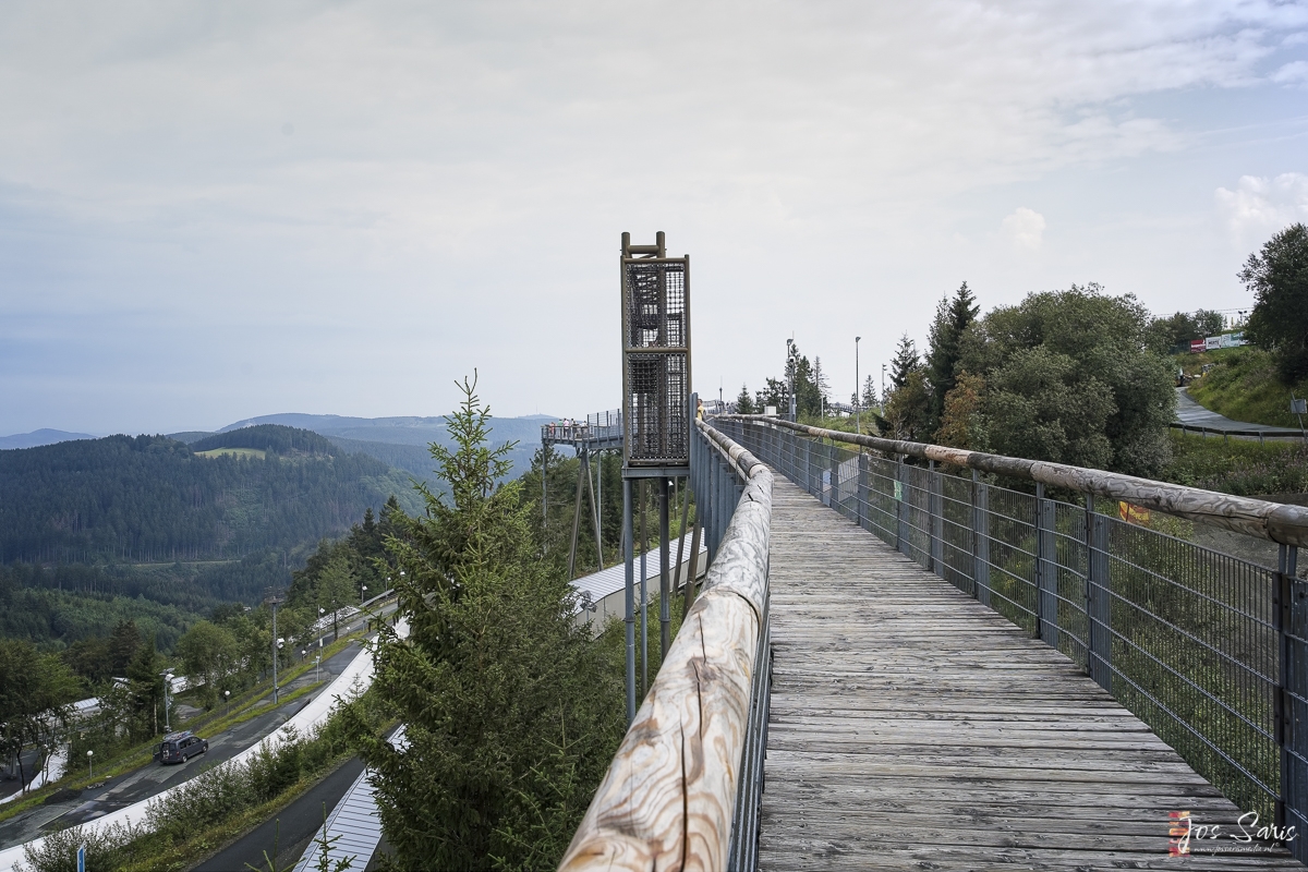 a wooden bridge over a road