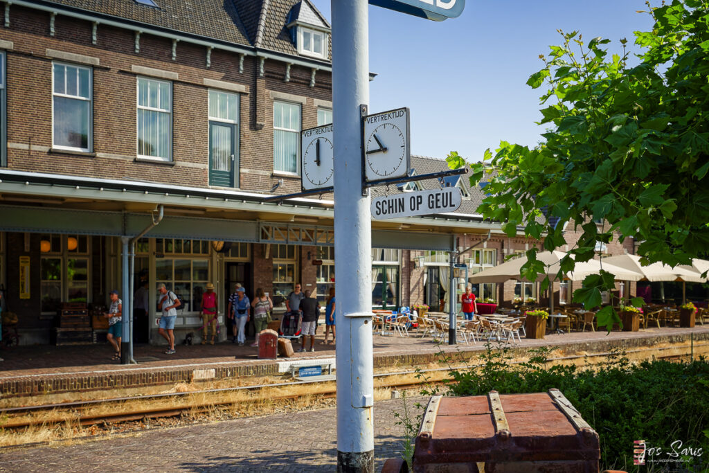 a sign post with a clock on it