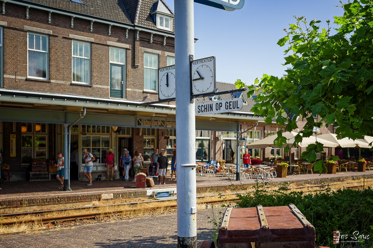 a sign post with a clock on it