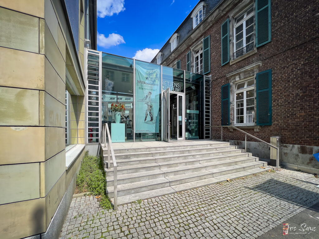 a building with stairs leading to a glass door