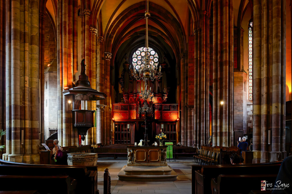 a church with a chandelier and a large window