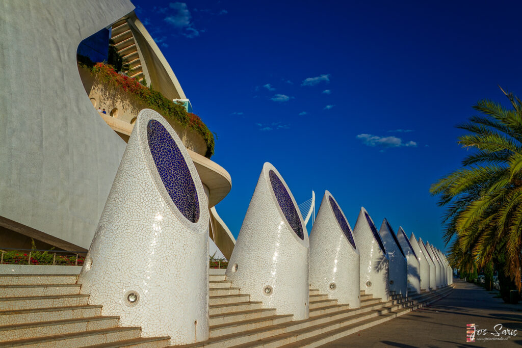 a white and blue building with a row of white and blue walls