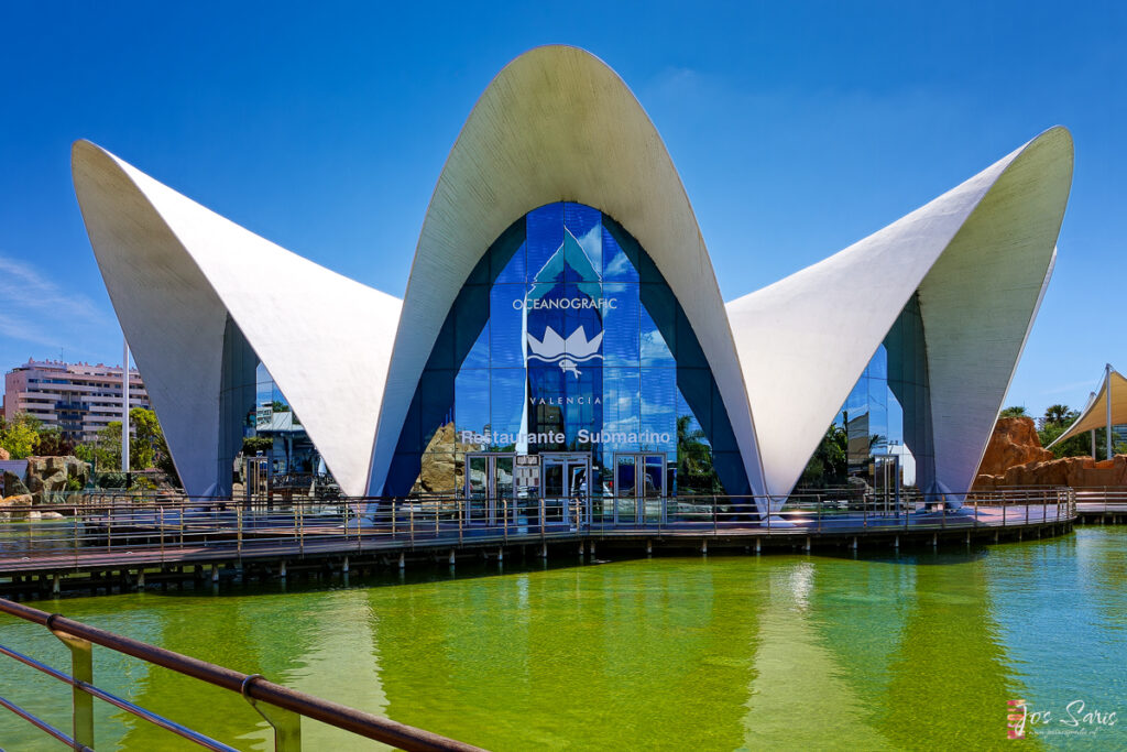 a building with a bridge and a body of water