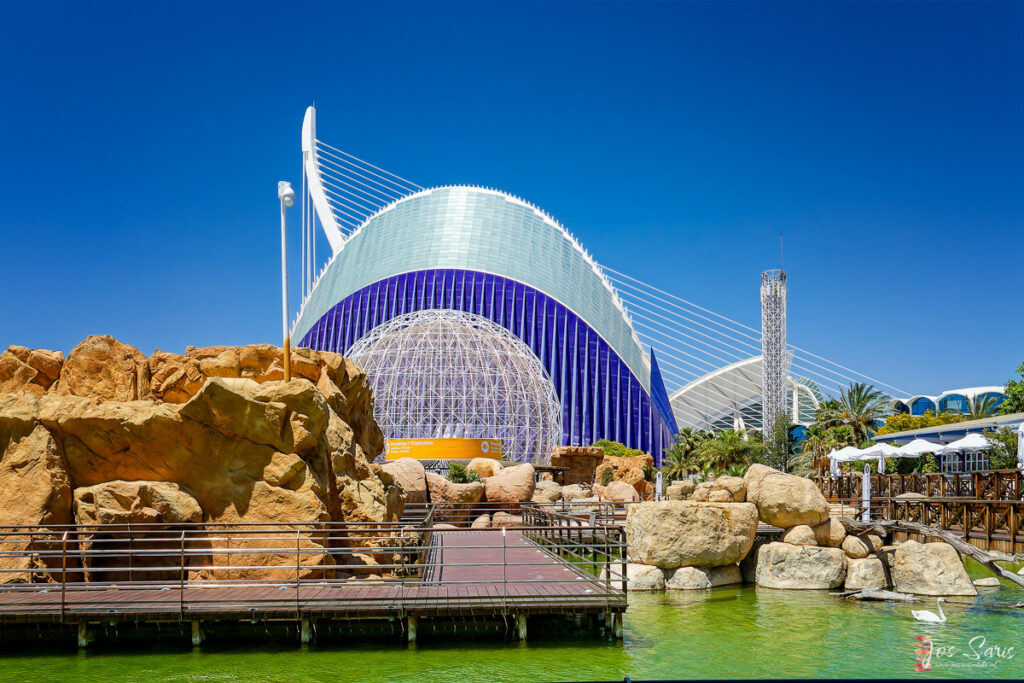 a building with a structure and rocks by it